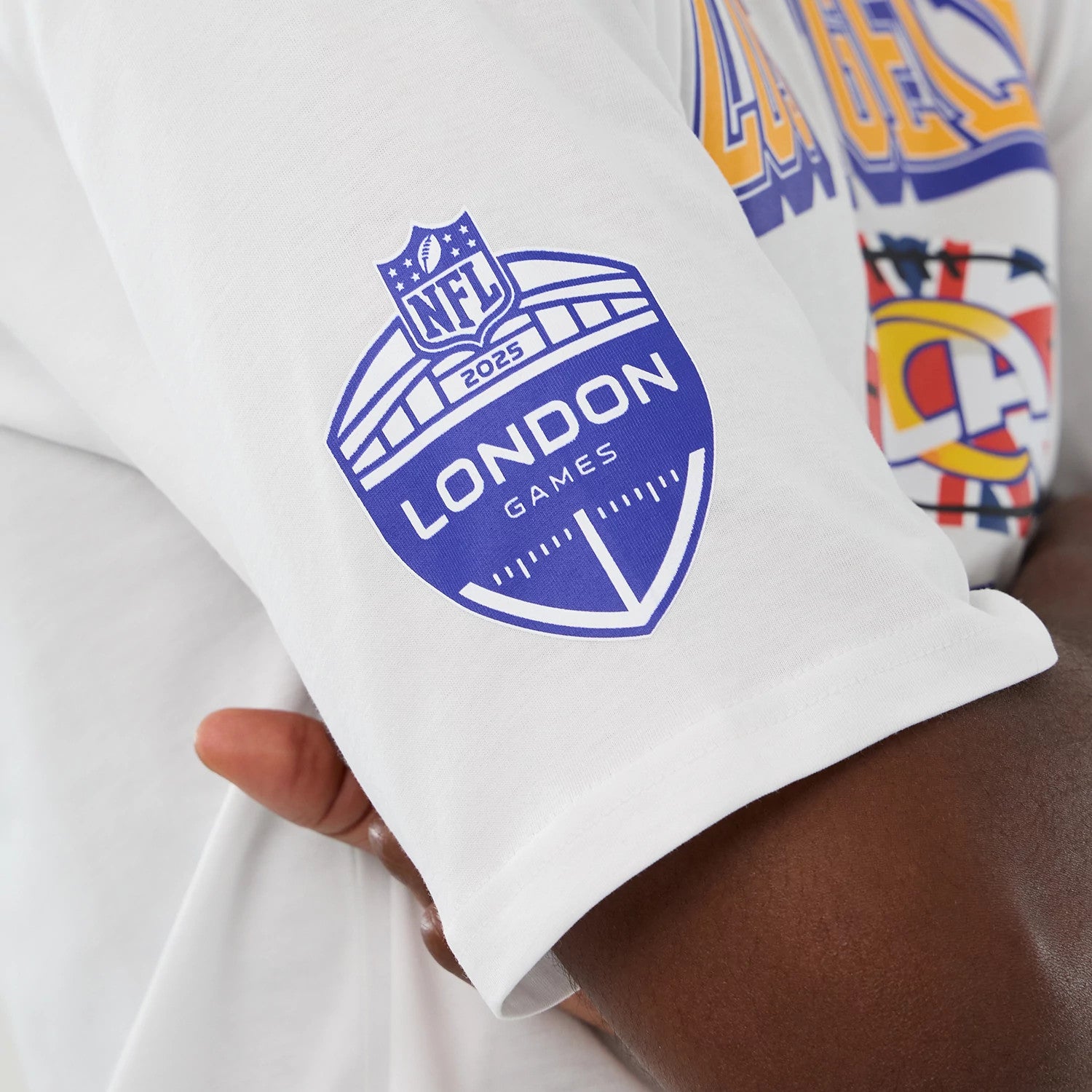 The Male model is wearing LA Rams NFL International Series Games 2025 White Oversized T-Shirt 4