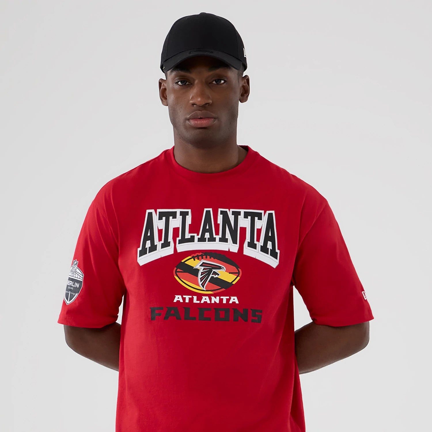 The Male model is wearing Atlanta Falcons NFL International Series Games 2025 Red Oversized T-Shirt 3