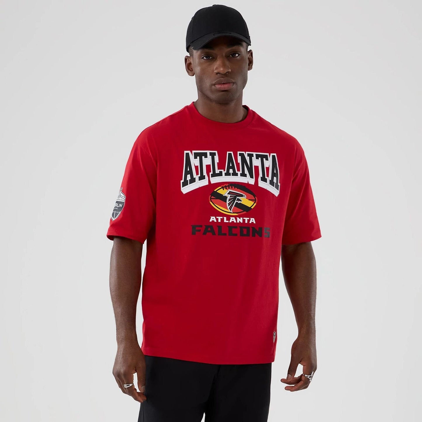 The Male model is wearing Atlanta Falcons NFL International Series Games 2025 Red Oversized T-Shirt  1
