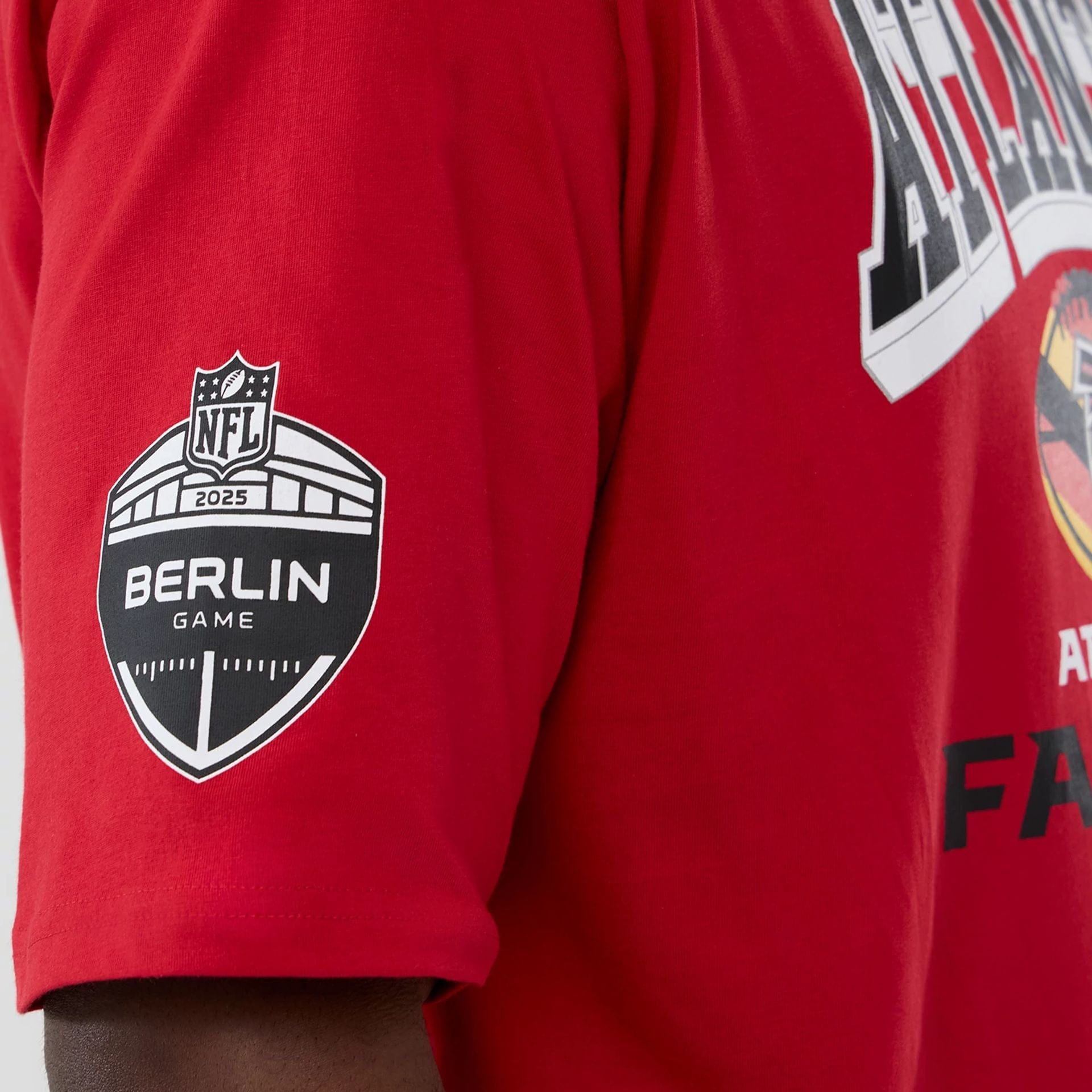 The Male model is wearing Atlanta Falcons NFL International Series Games 2025 Red Oversized T-Shirt  4