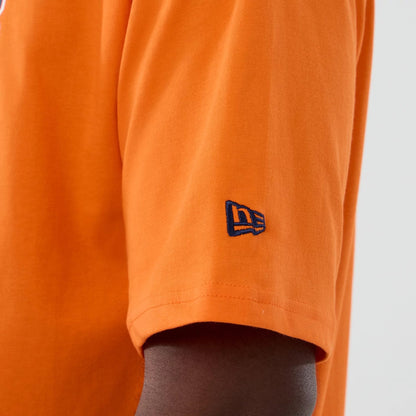The Male model is wearing Denver Broncos NFL International Series Games 2025 Orange Oversized T-Shirt  7