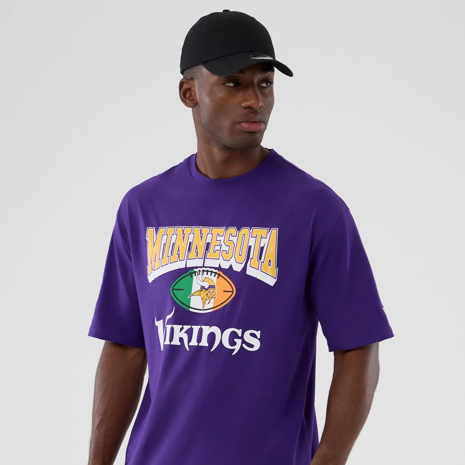 The Male model is wearing Minnesota Vikings NFL International Series Games 2025 Purple Oversized T-Shirt 3