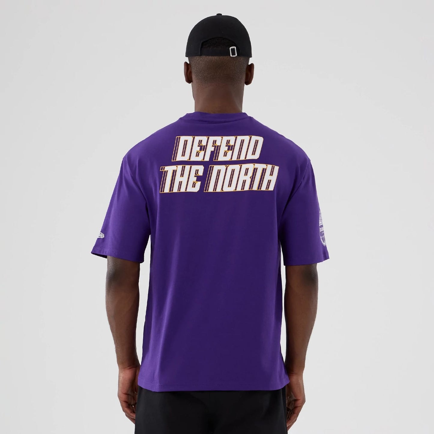 The Male model is wearing Minnesota Vikings NFL International Series Games 2025 Purple Oversized T-Shirt 2