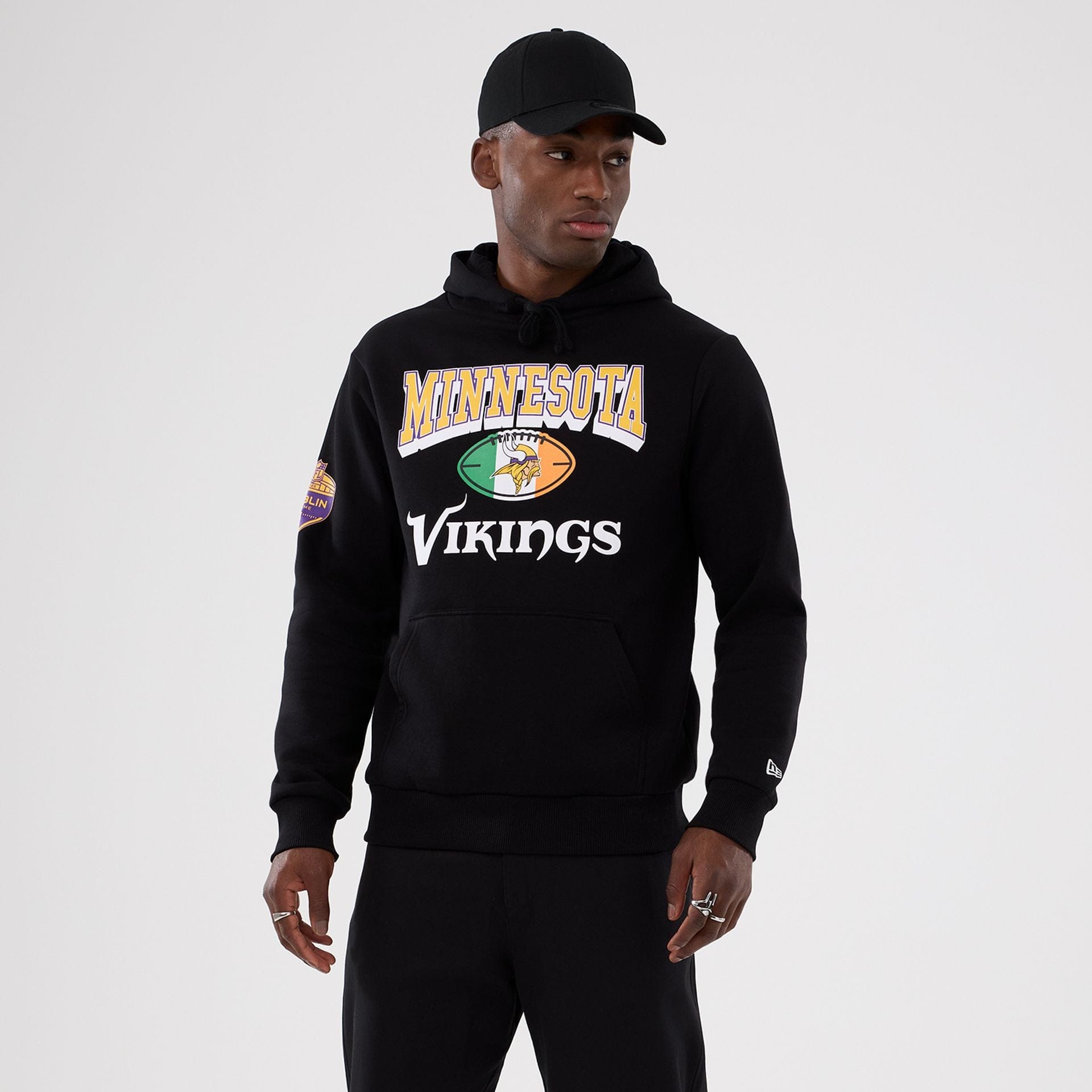 The Male model is wearing Minnesota Vikings NFL International Series Games 2025 Black Pullover Hoodie  1