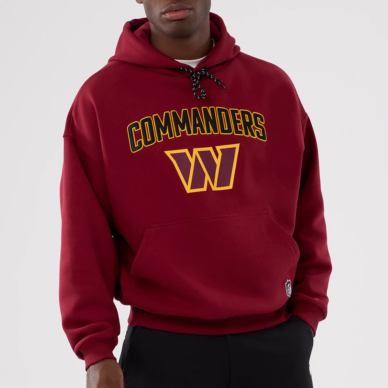 The Male model is wearing Washington Commanders NFL International Series Games 2025 Dark Red Premium Pullover Hoodie 7