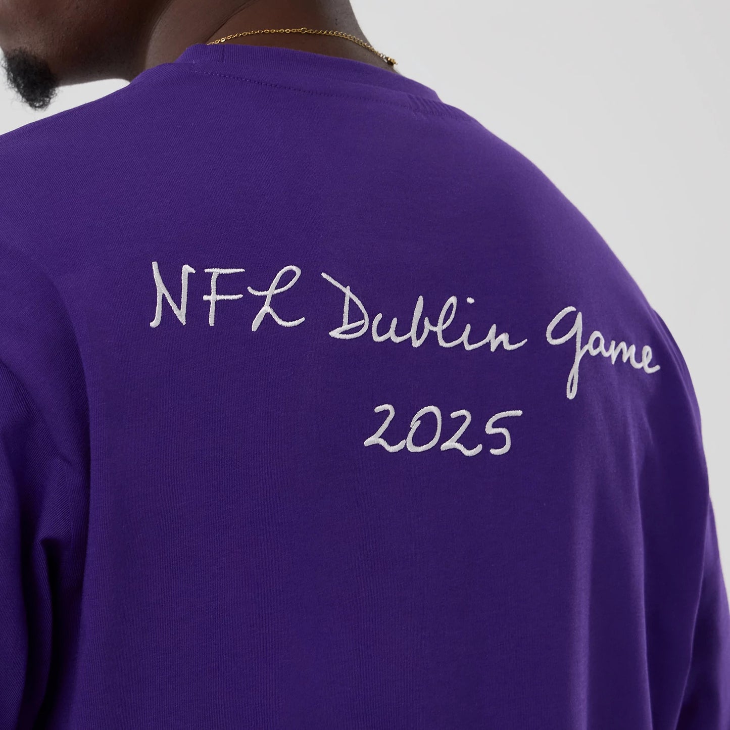 The Male model is wearing Minnesota Vikings NFL International Series Games 2025 Purple Premium T-Shirt 5