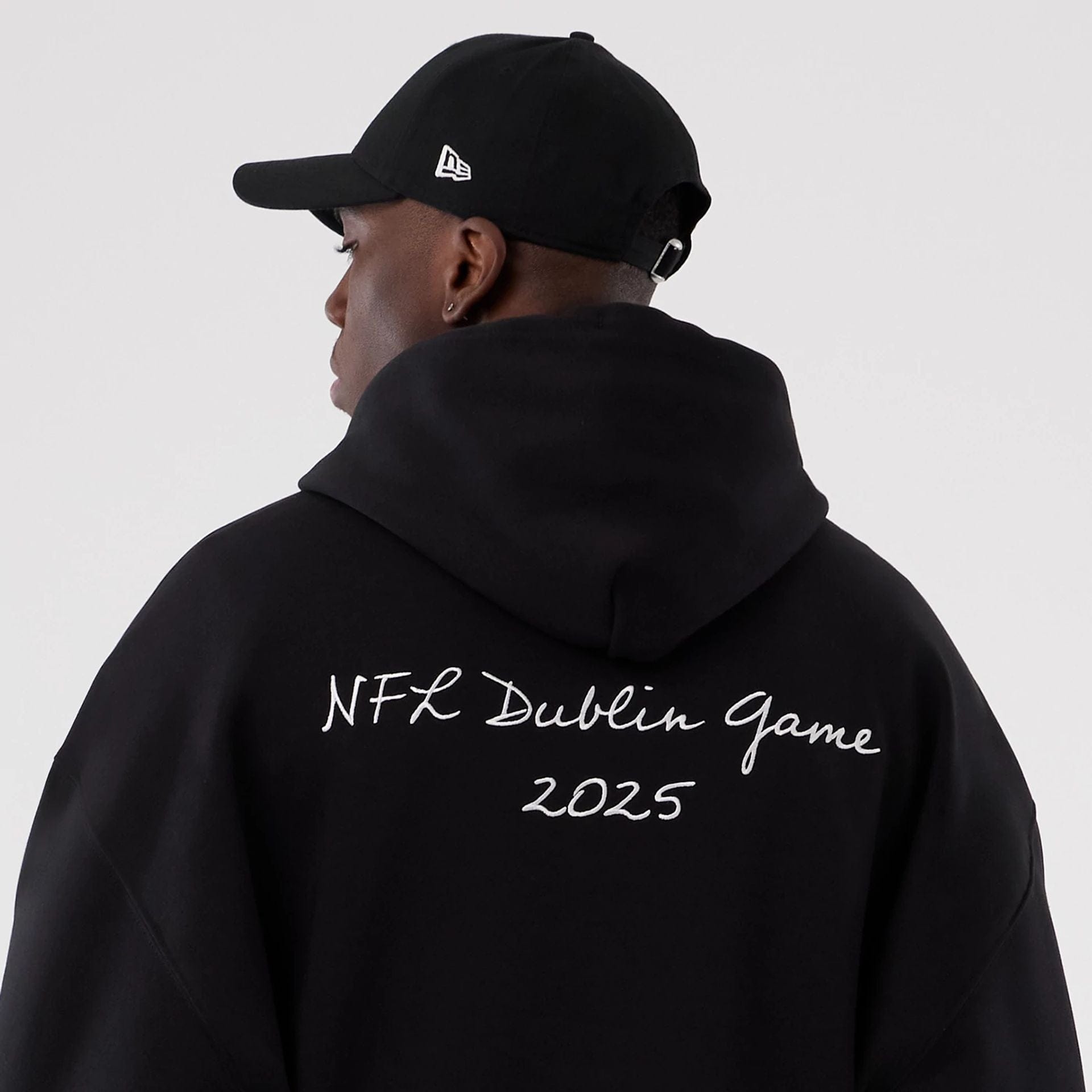 The Male model is wearing Minnesota Vikings NFL International Series Games 2025 Black Premium Pullover Hoodie  6