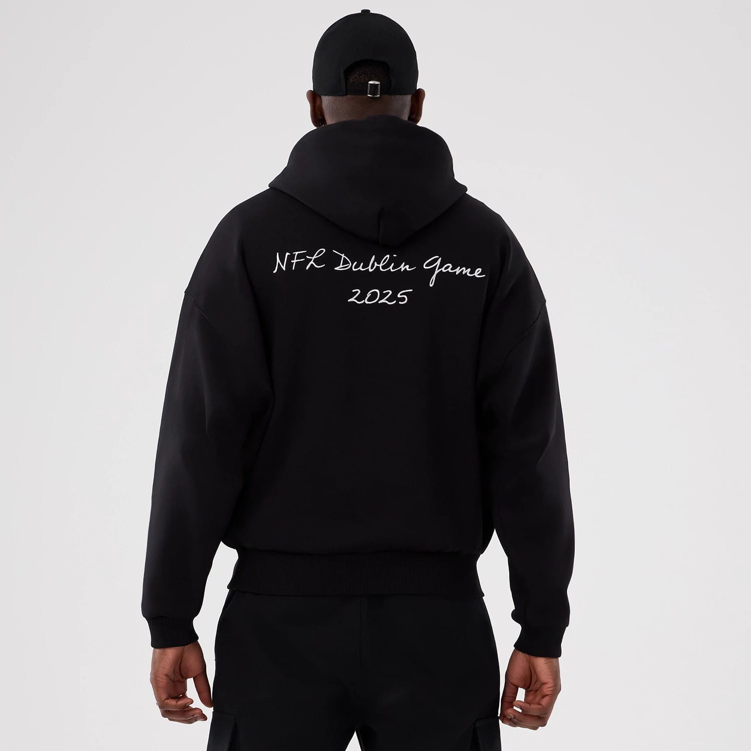The Male model is wearing Minnesota Vikings NFL International Series Games 2025 Black Premium Pullover Hoodie 2