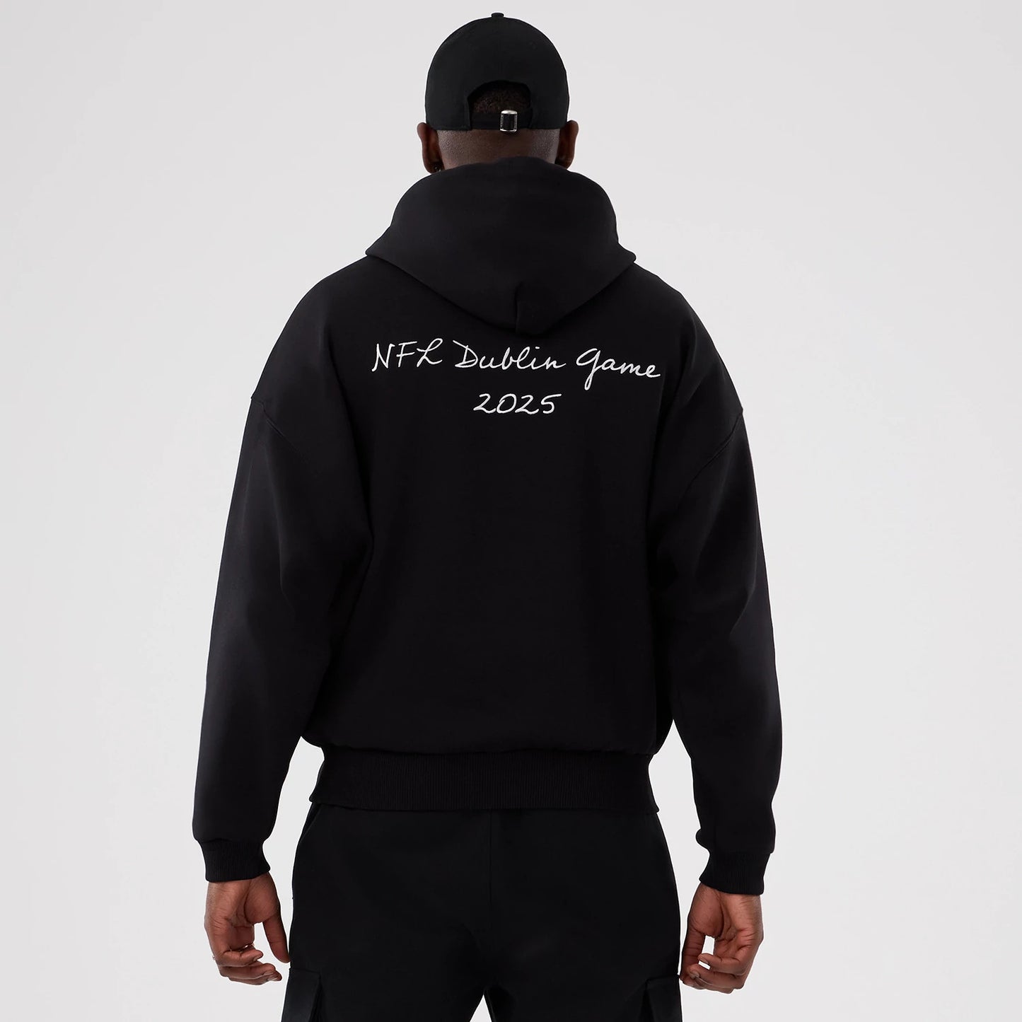 The Male model is wearing Minnesota Vikings NFL International Series Games 2025 Black Premium Pullover Hoodie 2