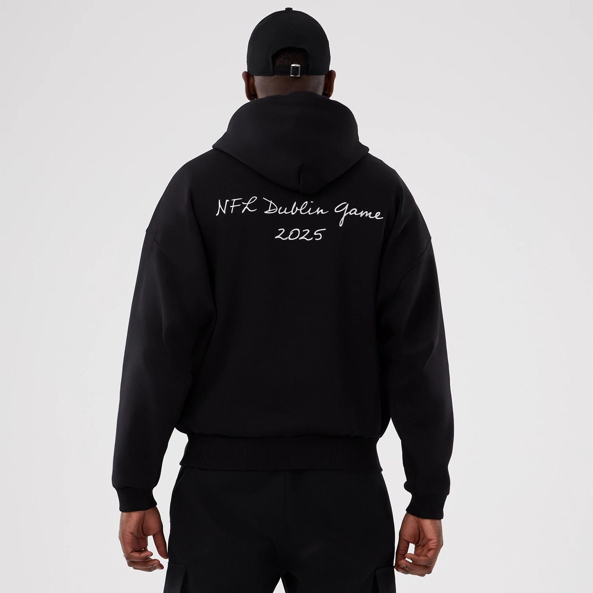 The Male model is wearing Minnesota Vikings NFL International Series Games 2025 Black Premium Pullover Hoodie  2