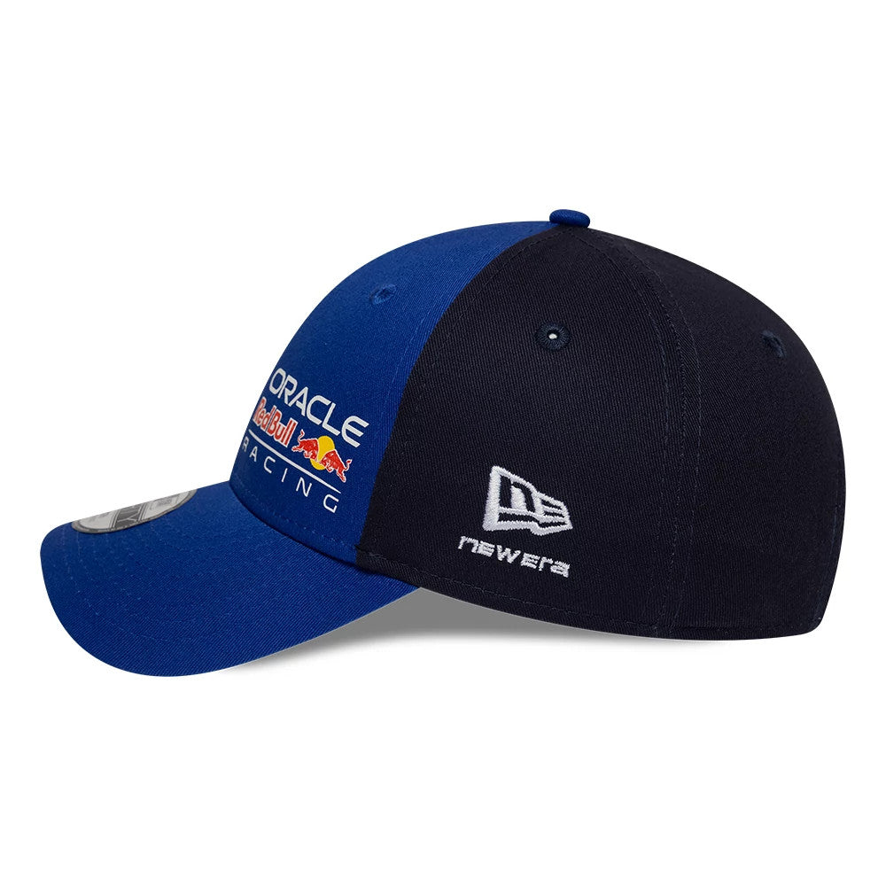 Red Bull Racing Youth Essential Dark Blue New Era 9FORTY Adjustable Cap, side view showing the embroidered New Era flag logo in white on the blue and dark blue crown with a curved blue visor featuring a 9FORTY size sticker.