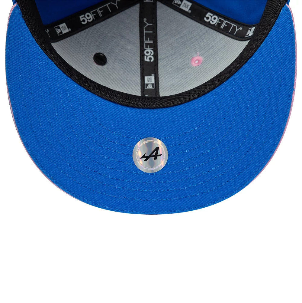 Alpine Racing Summer League Blue New Era 59FIFTY Fitted Cap, inside view showing the grey undervisor with a circular holographic sticker, black taping with 59FIFTY branding, and a pink eyelet detail against the blue fabric.