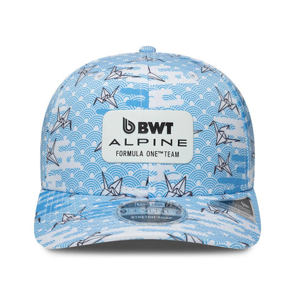 Alpine Racing Japan Race Special White New Era 9SEVENTY Stretch Snap Adjustable Cap, front view showing a white BWT Alpine Formula One Team logo patch on a blue wave and crane pattern, with a 9SEVENTY size sticker on the curved visor.