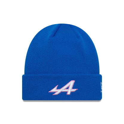 New Era Alpine Racing Essential Blue Cuff Knit Beanie Hat, front view with white and pink embroidered Alpine A logo on the cuff and the New Era flag logo on the side of the bright blue knit fabric.