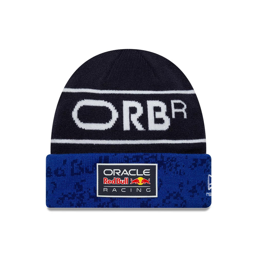 New Era Red Bull Racing Team Dark Blue Cuff Knit Beanie Hat, front view showing white ORBR lettering across the top, with a blue cuff featuring the Oracle Red Bull Racing logo patch and a New Era flag logo on the side.