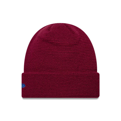 EDWIN x New Era Dark Red Cuff knit Beanie Hat, front view showing a textured knit pattern with a turned-up cuff and contrasting blue New Era flag logo embroidered on the left side.
