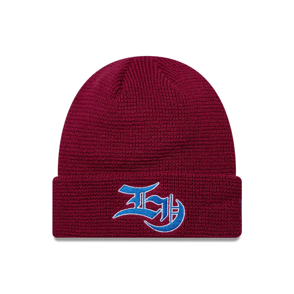 EDWIN x New Era Dark Red Cuff knit Beanie Hat, front view showing a light blue embroidered logo centred on the folded cuff of the richly textured dark red beanie.