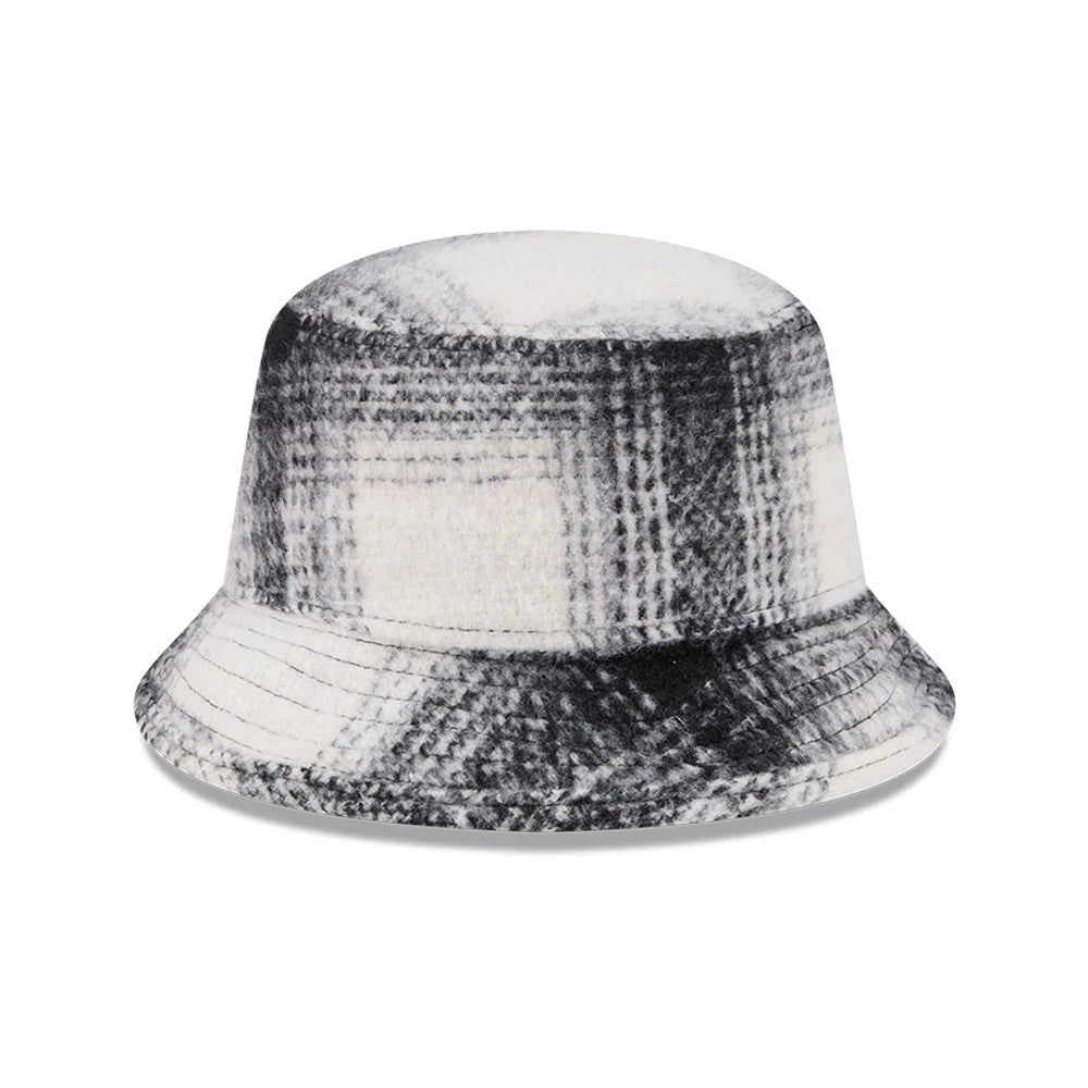 New Era White & Black Plaid Bucket Hat, three-quarter view showing the soft fabric with a black and white plaid pattern covering the entire crown and visor, offering a and casual look.