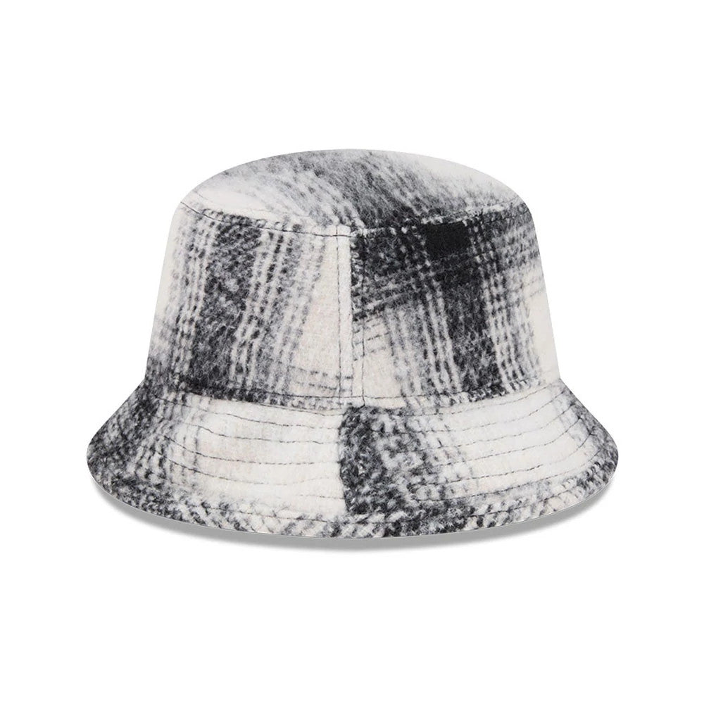New Era White & Black Plaid Bucket Hat, front view showing a classic plaid pattern with shades of white and black across the soft, structured crown and wide, downward-sloping visor for a timeless look.