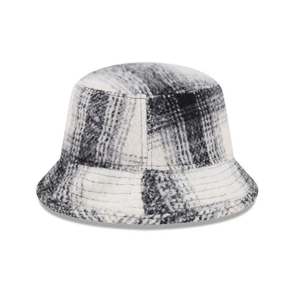 New Era White & Black Plaid Bucket Hat, front view showing a classic plaid pattern with shades of white and black across the soft, structured crown and wide, downward-sloping visor for a timeless look.