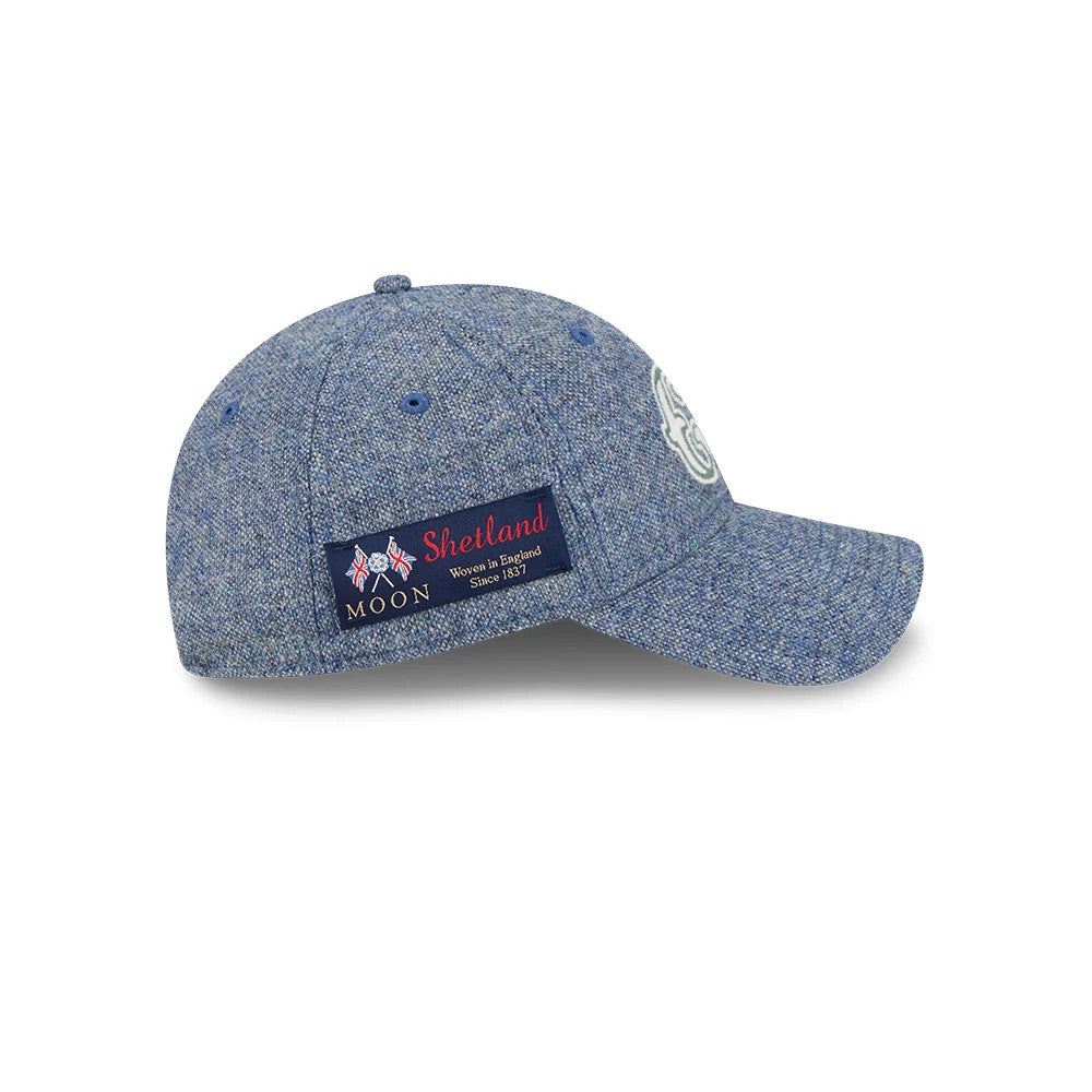 Chicago Cubs MLB X Moon Blue New Era 9TWENTY Adjustable Cap, side view showing a woven patch with Shetland text detail on the right panel and a curved visor, with an embroidered Cubs logo on the front panel.