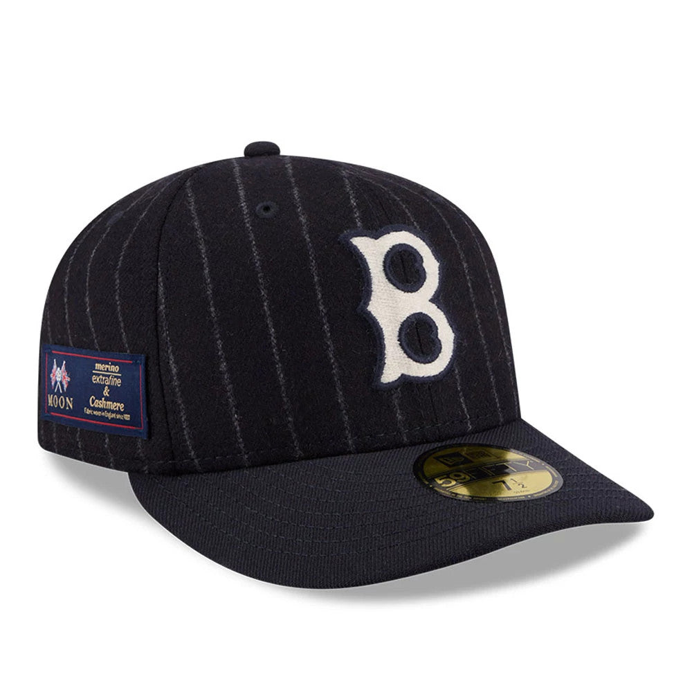 Boston Red Sox MLB X Moon Navy New Era 59FIFTY Fitted Cap, three-quarter view showing the white embroidered B logo on the pinstriped navy crown, with a woven Moon label on the side and a gold 59FIFTY size sticker on the flat navy visor.