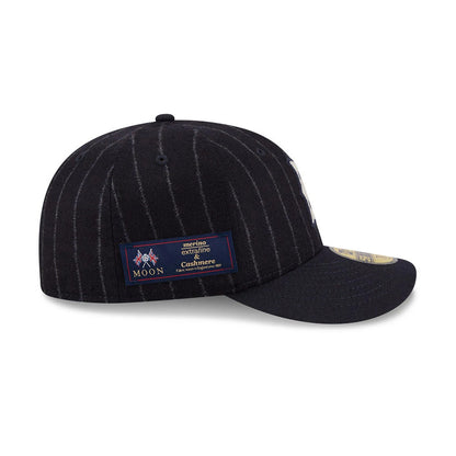 Boston Red Sox MLB X Moon Navy New Era 59FIFTY Fitted Cap, side view showing a woven Moon label on the left panel of the pinstriped wool crown, with a flat navy visor featuring a gold 59FIFTY size sticker.