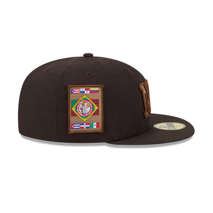 New York Black Yankees MLB Negro League Dark Brown New Era 59FIFTY Fitted Cap, side view showing a colourful embroidered patch with flags on the right side of the dark brown crown, and a flat visor with a gold 59FIFTY size sticker.
