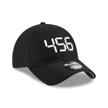 Netflix Squid Game 456 Black New Era 9TWENTY Adjustable Cap, front view showing the raised white embroidered number 456 on the structured black crown, with a rounded black visor and a 9TWENTY size sticker on the visor.
