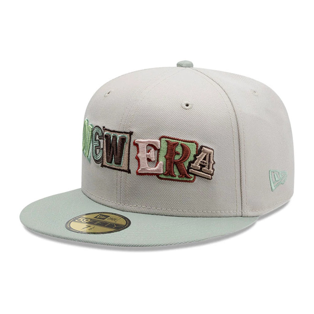 New Era DIY Note Light Beige New Era 59FIFTY Fitted Cap, three-quarter view showing colourful embroidered letters spelling 'NEW ERA' across the front panels, a matching light beige visor and a gold 59FIFTY size sticker on the visor.