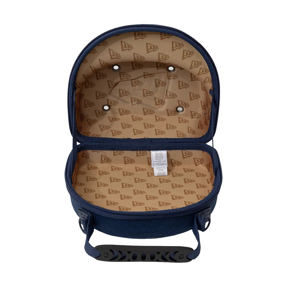 New Era Denim Navy 2Pk 59FIFTY Cap Carrier, open view displaying the interior with a beige lining featuring a repeated New Era logo print, two rows of evenly spaced eyelets, and a tag on the lower section of the carrier.