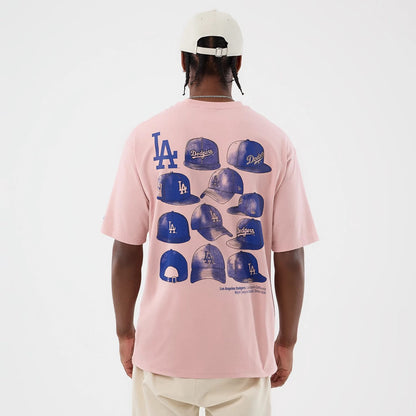 The model is wearing this MLB Cap Graphic LA Dodgers Oversized T-Shirt in pastel pink. 2
