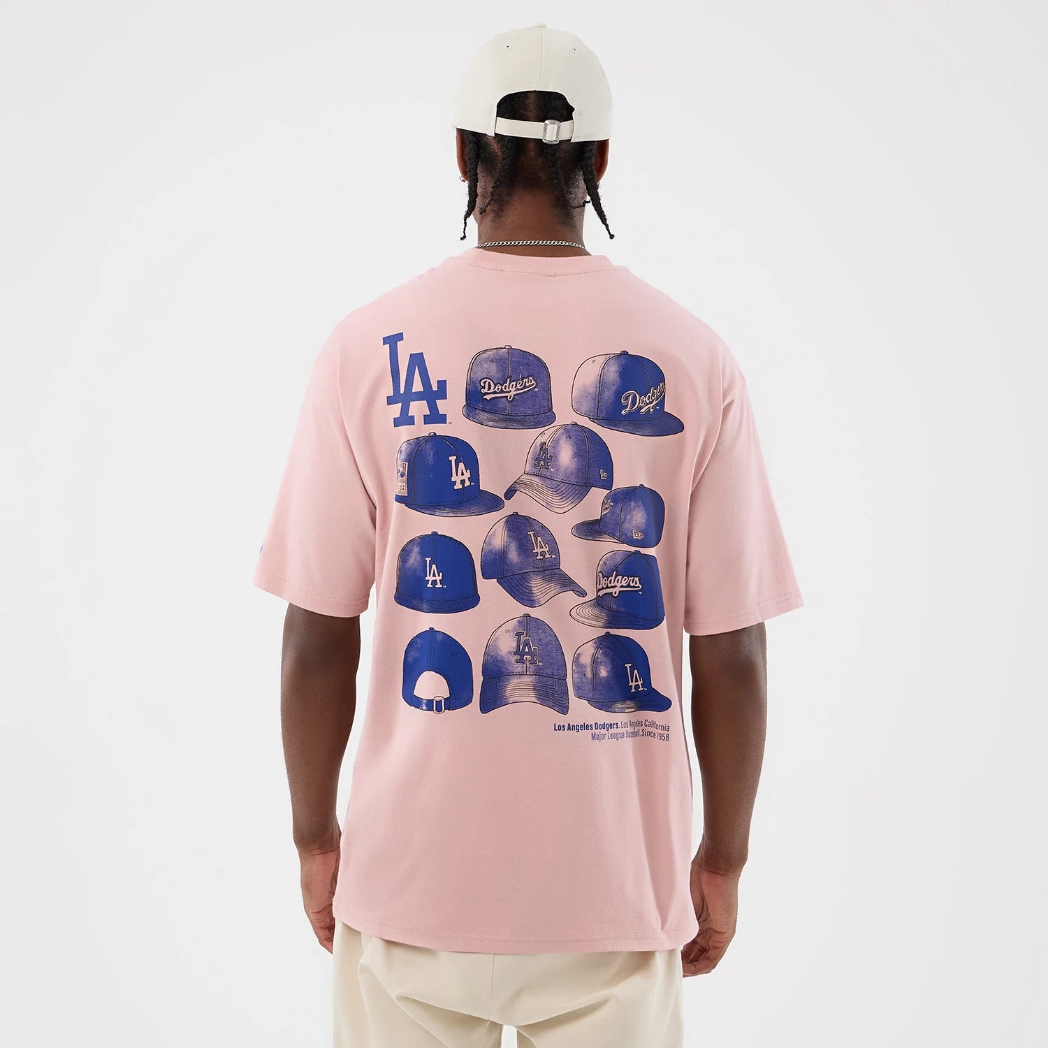 The model is wearing this MLB Cap Graphic LA Dodgers Oversized T-Shirt in pastel pink. 2