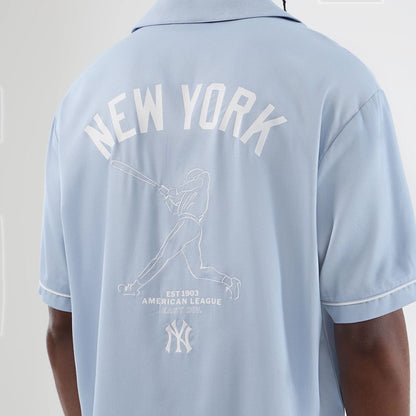 The model is wearing this MLB Graphic Revere New York Yankees Short Sleeve Shirt in pastel blue. 4