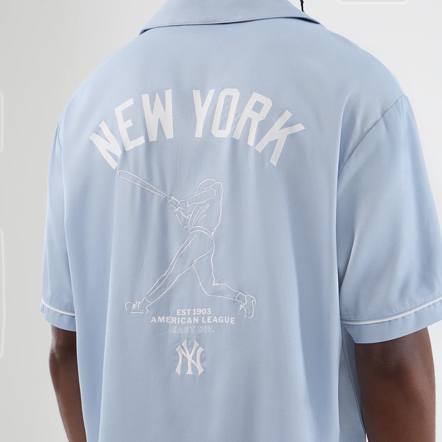 The model is wearing this MLB Graphic Revere New York Yankees Short Sleeve Shirt in pastel blue. 4