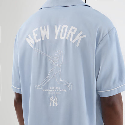 The model is wearing this MLB Graphic Revere New York Yankees Short Sleeve Shirt in pastel blue. 4