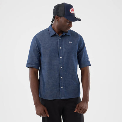 The model is wearing this New Era Denim Short Sleeve Shirt in blue. 3