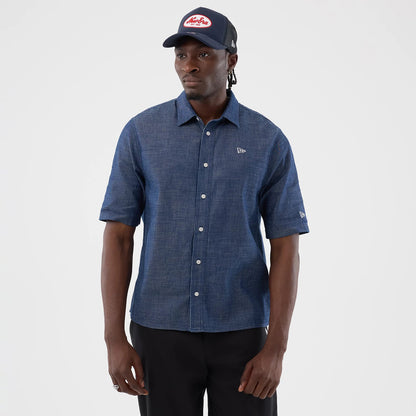 The model is wearing this New Era Denim Short Sleeve Shirt in blue. 1
