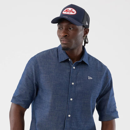 The model is wearing this New Era Denim Short Sleeve Shirt in blue. 6
