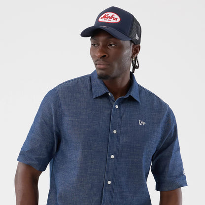The model is wearing this New Era Denim Short Sleeve Shirt in blue. 6