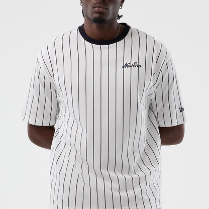 The model is wearing this New Era Pinstripe Oversized T-Shirt in Open White. 4