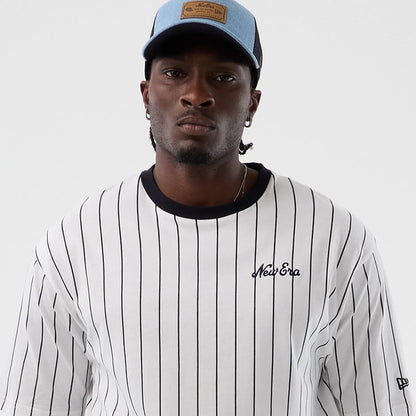 The model is wearing this New Era Pinstripe Oversized T-Shirt in Open White. 6