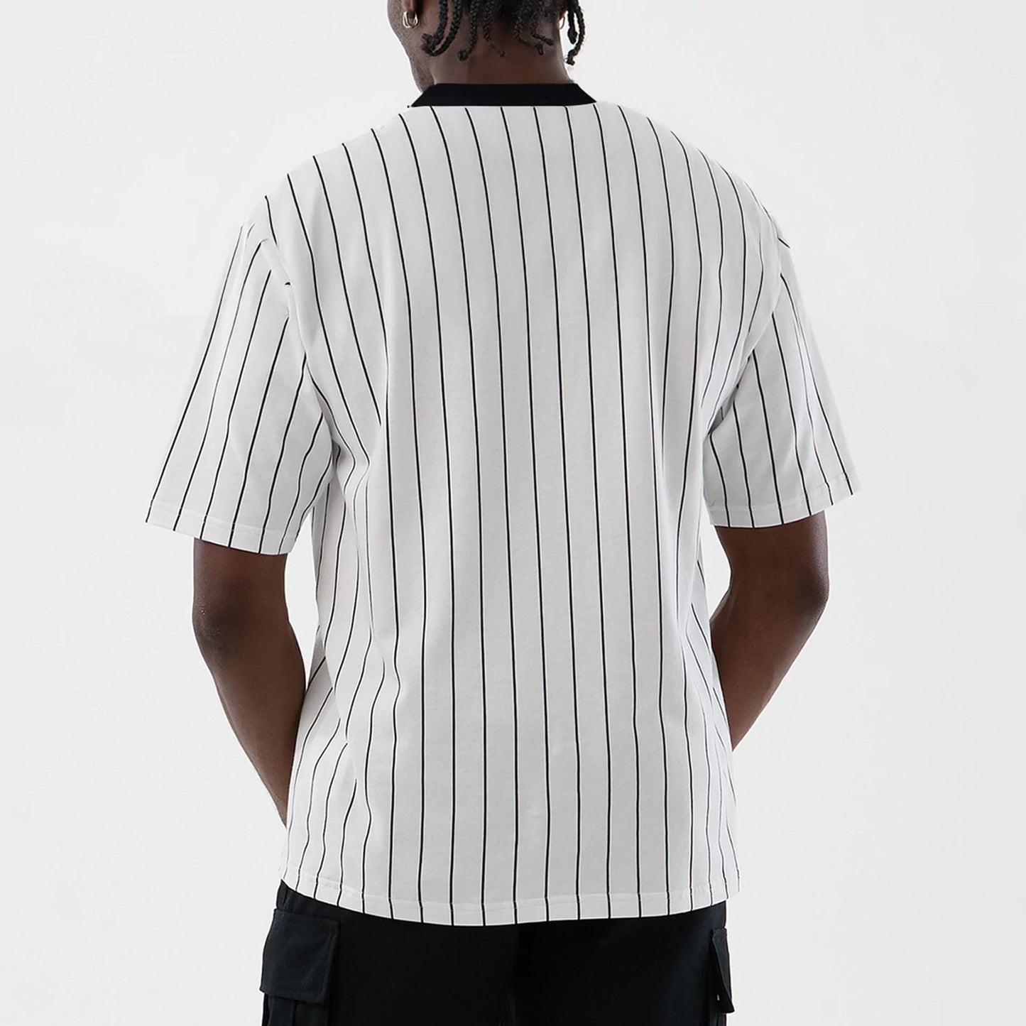 The model is wearing this New Era Pinstripe Oversized T-Shirt in Open White. 2