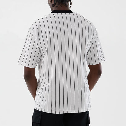 The model is wearing this New Era Pinstripe Oversized T-Shirt in Open White. 2