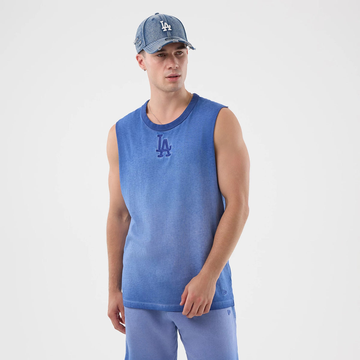 New Era LA Dodgers MLB Washed Logo Pastel Blue Vest, front view on a model showing the dark blue embroidered LA logo centred on the chest, with a relaxed fit and contrasting darker blue ribbed neckline and armholes.