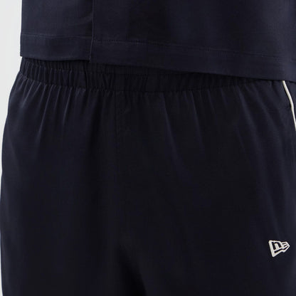 The model is wearing this New Era Piping Shorts in navy. 5