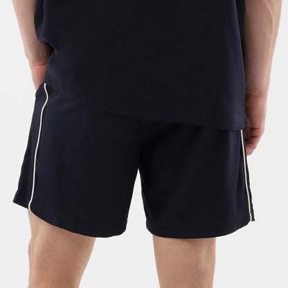 The model is wearing this New Era Piping Shorts in navy. 6