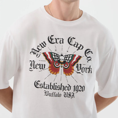 The model is wearing this New Era Death Moth Graphic Oversized T-Shirt in white. 4
