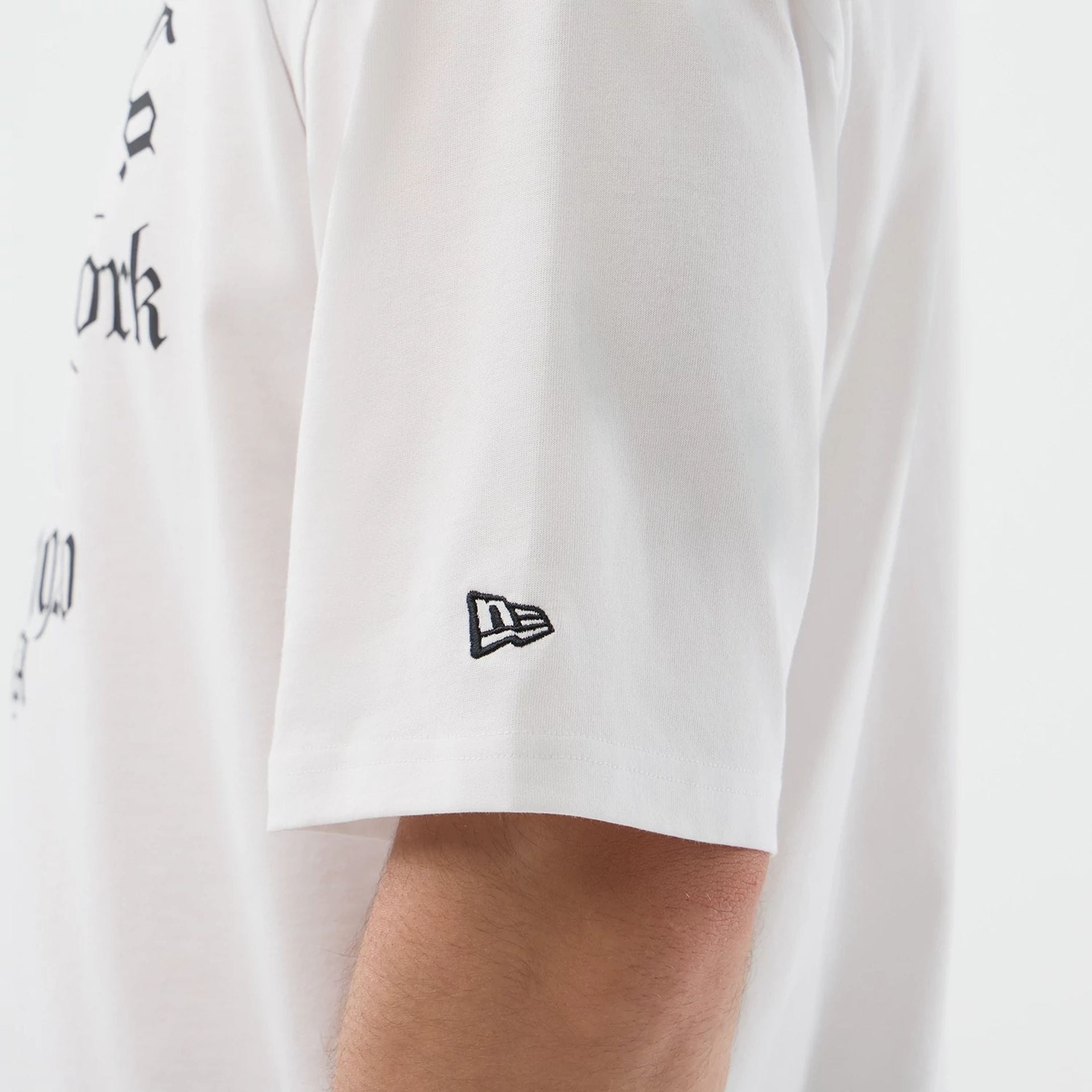 The model is wearing this New Era Death Moth Graphic Oversized T-Shirt in white. 5