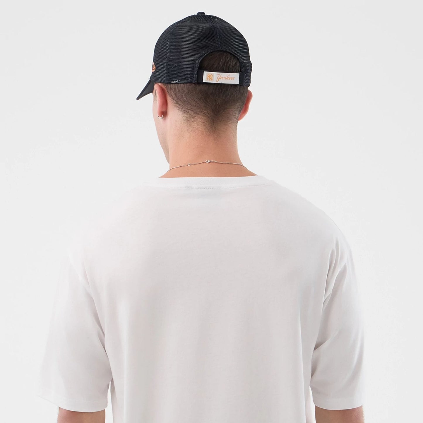 The model is wearing this New Era Death Moth Graphic Oversized T-Shirt in white. 7